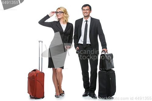 Image of Businessman and business woman with travel cases