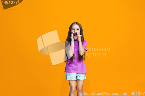 Image of Isolated on orange young casual teen girl shouting at studio