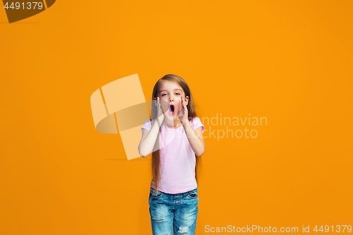 Image of Isolated on orange young casual teen girl shouting at studio