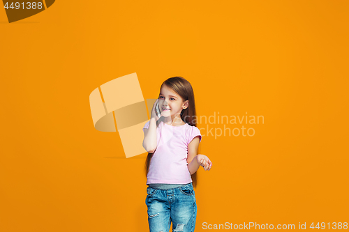 Image of The happy teen girl standing and smiling with phone