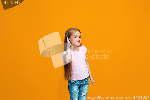 Image of The young teen girl whispering a secret behind her hand