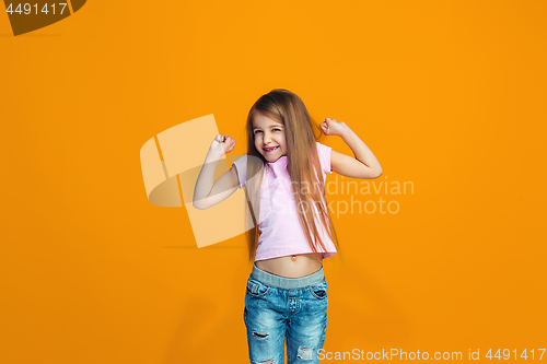 Image of Happy success teen girl celebrating being a winner. Dynamic energetic image of female model