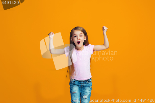 Image of Happy success teen girl celebrating being a winner. Dynamic energetic image of female model