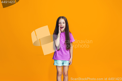 Image of Isolated on orange young casual teen girl shouting at studio