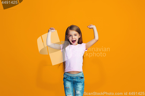 Image of Happy success teen girl celebrating being a winner. Dynamic energetic image of female model