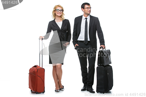 Image of Businessman and business woman with travel cases