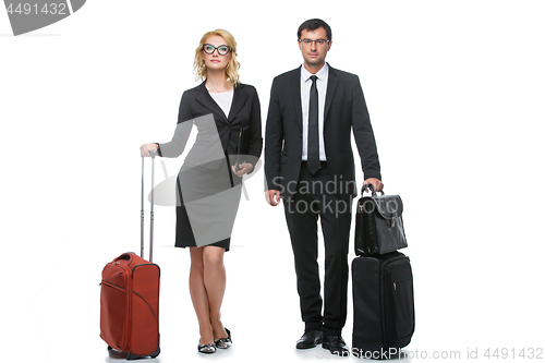 Image of Businessman and business woman with travel cases