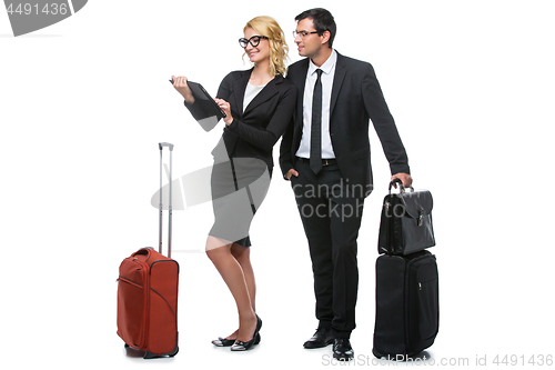 Image of Businessman and business woman with travel cases