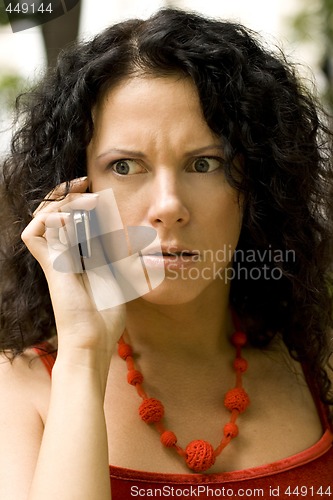 Image of woman on phone getting bad news