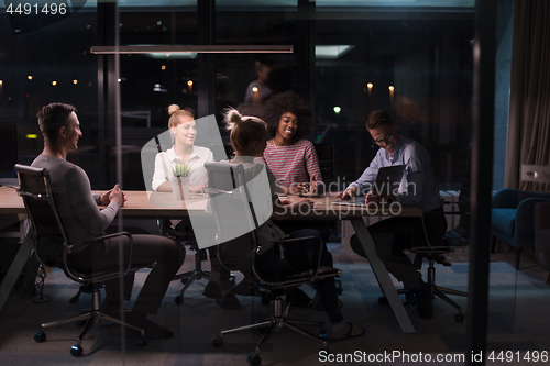 Image of Multiethnic startup business team in night office