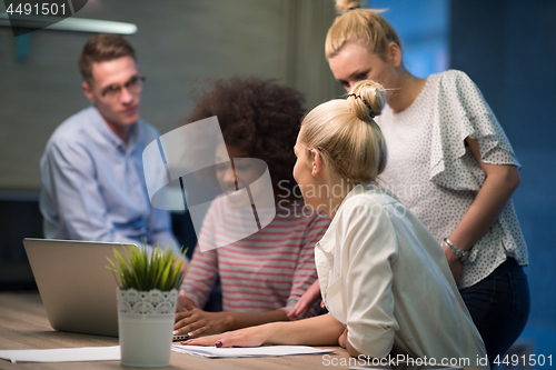 Image of Multiethnic startup business team in night office