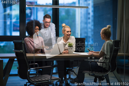 Image of Multiethnic startup business team in night office