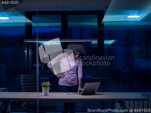 Image of black businesswoman using a laptop in startup office