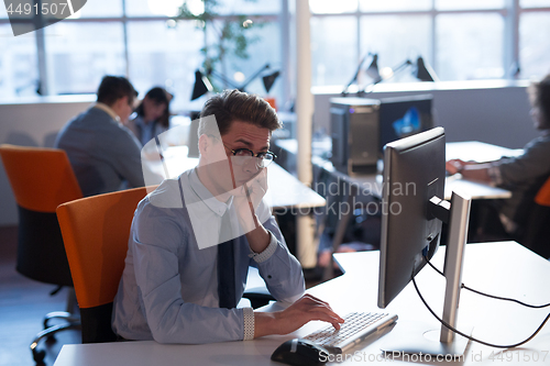 Image of businessman working using a computer in startup office