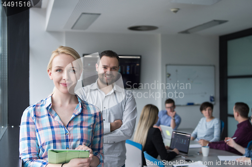 Image of Business People Working With Tablet in startup office