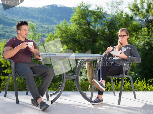 Image of couple enjoying morning coffee and breakfast