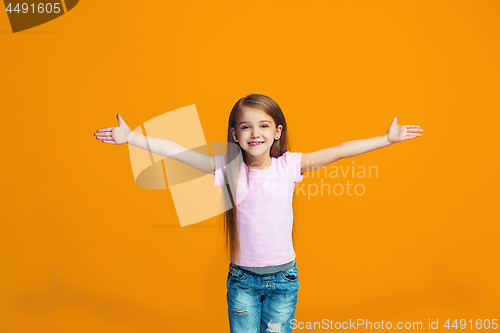 Image of Happy success teen girl celebrating being a winner. Dynamic energetic image of female model