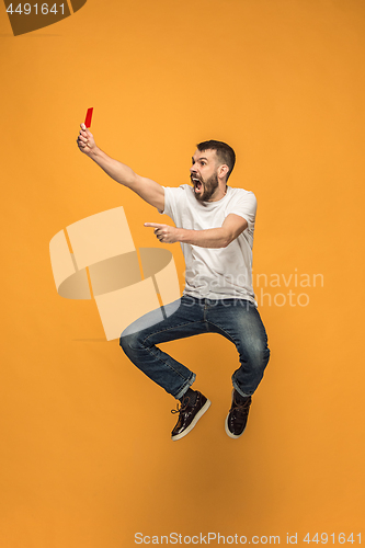 Image of Football supporter with red card on orange background