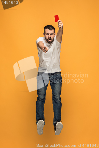 Image of Football supporter with red card on orange background