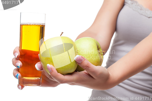 Image of Beautiful girl hands with apple and glass of juice