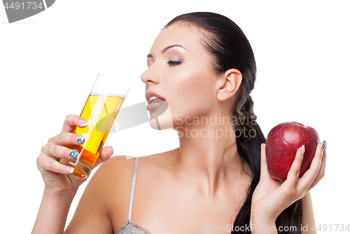 Image of Beautiful girl with apple and glass of juice