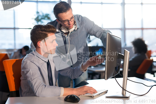 Image of Two Business People Working With computer in office