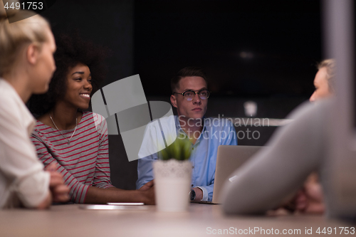 Image of Multiethnic startup business team in night office