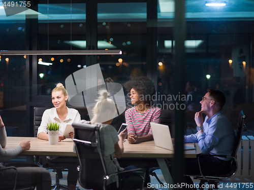 Image of Multiethnic startup business team in night office