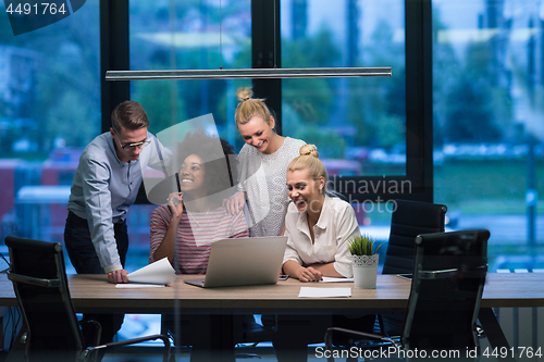 Image of Multiethnic startup business team in night office