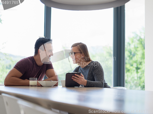 Image of couple enjoying morning coffee and strawberries