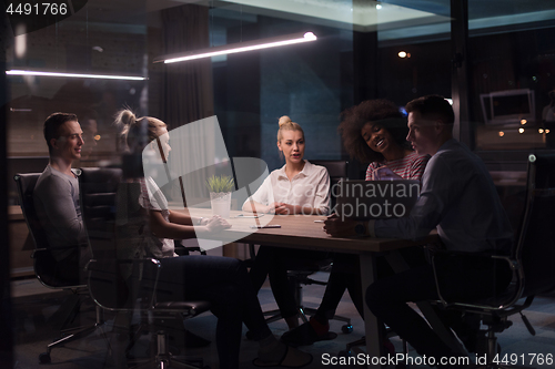 Image of Multiethnic startup business team in night office