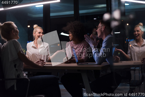 Image of Multiethnic startup business team in night office