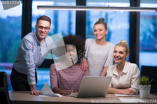 Image of Multiethnic startup business team in night office