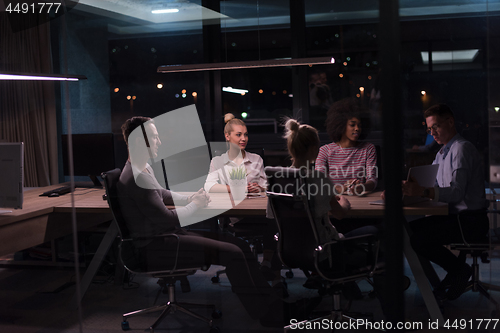 Image of Multiethnic startup business team in night office