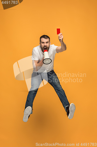 Image of Football supporter with red card on orange background