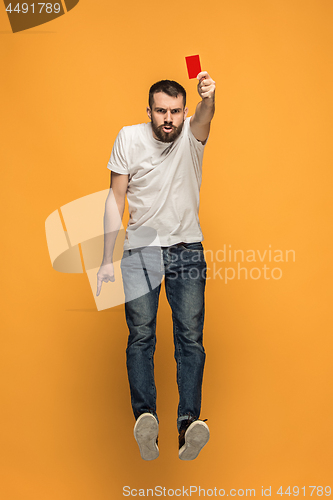 Image of Football supporter with red card on orange background