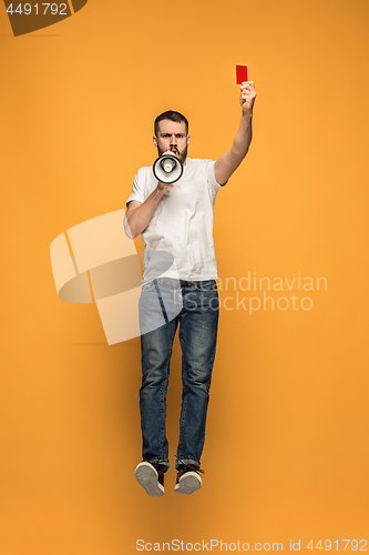 Image of Football supporter with red card on orange background