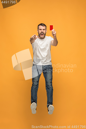 Image of Football supporter with red card on orange background