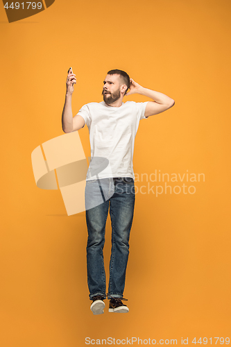 Image of Full length of handsome young man taking selfie while jumping