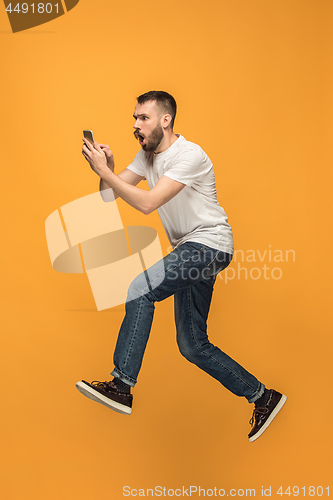 Image of Full length of handsome young man taking selfie while jumping