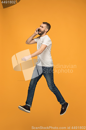 Image of Full length of handsome young man taking selfie while jumping