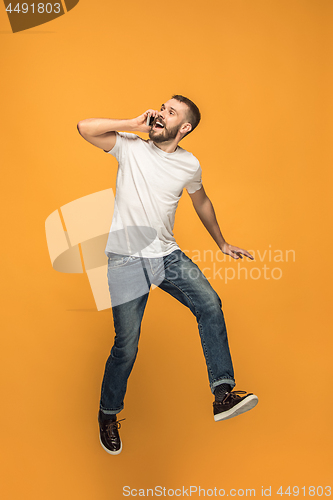 Image of Full length of handsome young man taking selfie while jumping