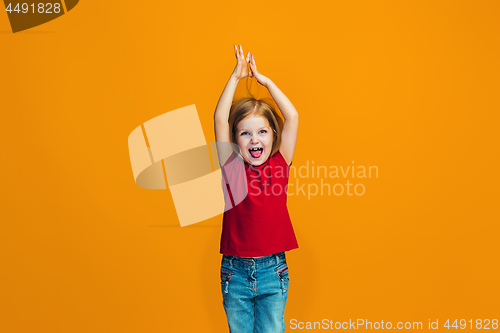 Image of Happy success teen girl celebrating being a winner. Dynamic energetic image of female model