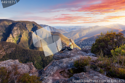 Image of Female hiker admiring mountain wilderness beauty