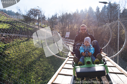 Image of father and son enjoys driving on alpine coaster