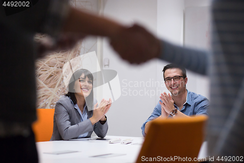 Image of cloasing the deal in modern office interior