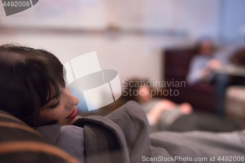 Image of software developers sleeping on sofa in creative startup office