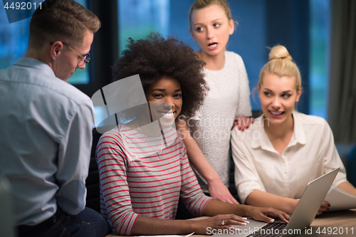 Image of Multiethnic startup business team in night office