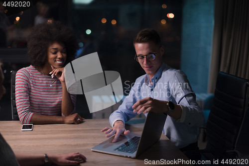 Image of Multiethnic startup business team in night office