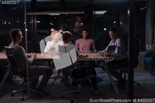 Image of Multiethnic startup business team in night office